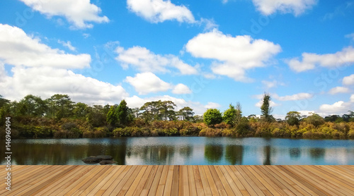 Wooden deck with beautiful lake and blue sky