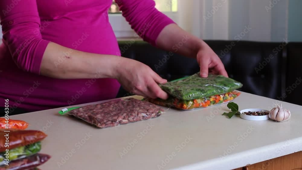Pregnant Woman Preparing Frozen Meals Pregnant Woman Preparing Frozen Meals
