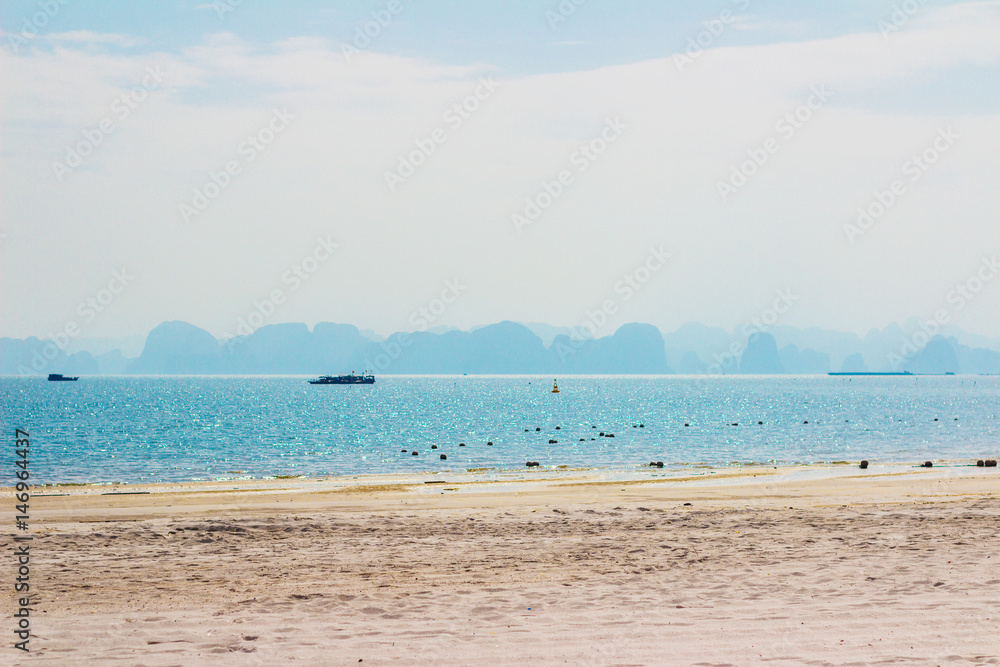 The morning view of the palm tree beach in Ha Long (Halong) bay. Vietnam, Southeast Asia UNESCO World Heritage Site. The morning view of the palm tree beach in Ha Long (Halong) bay. Vietnam, Southeast Asia UNESCO World Heritage Site.