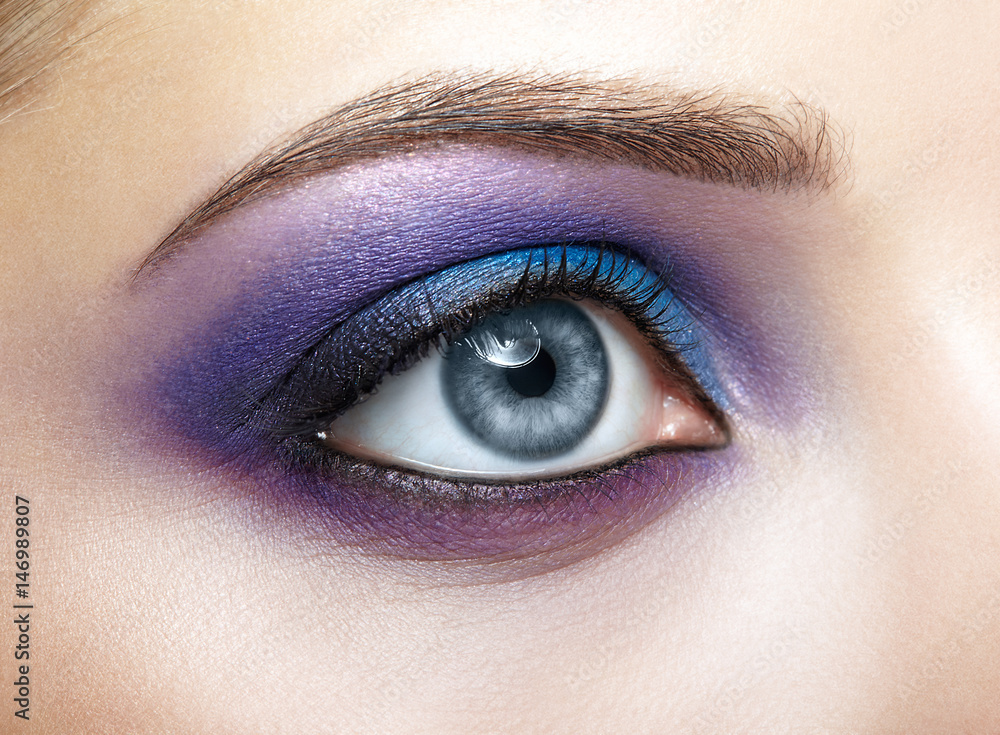 Female eye with blue and violet makeup