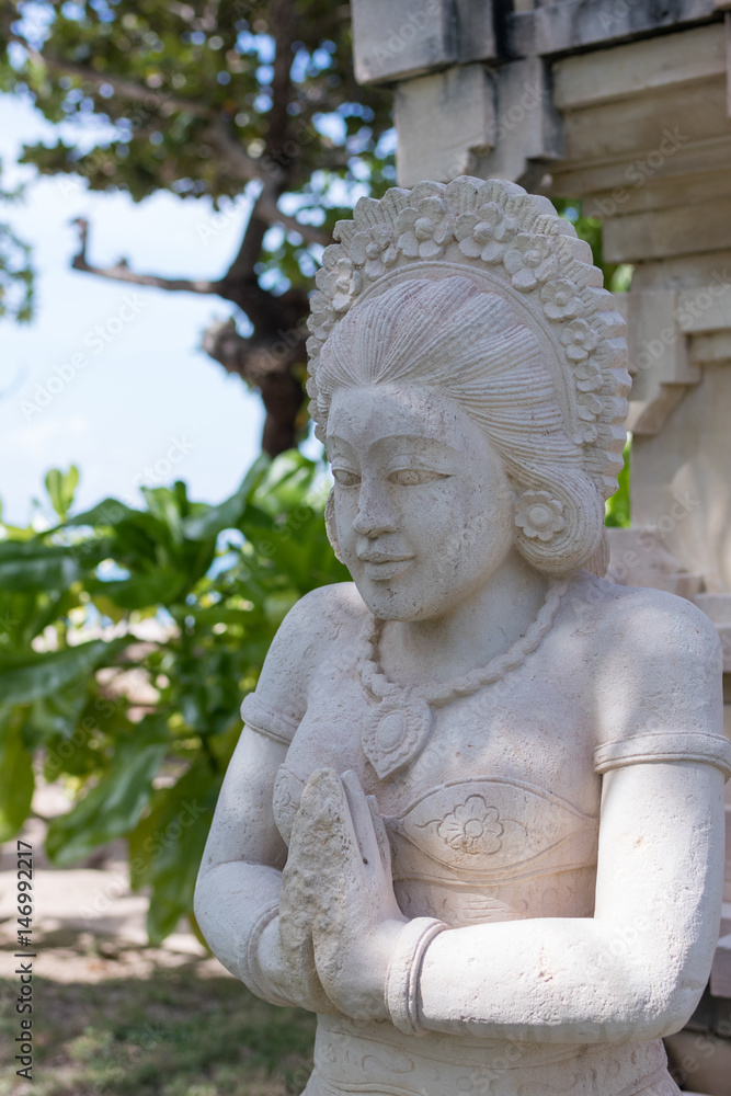Traditional balinese statue in the public park. Bali island, Indonesia.