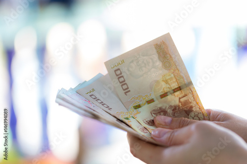 Woman is counting Thai's money in her hand