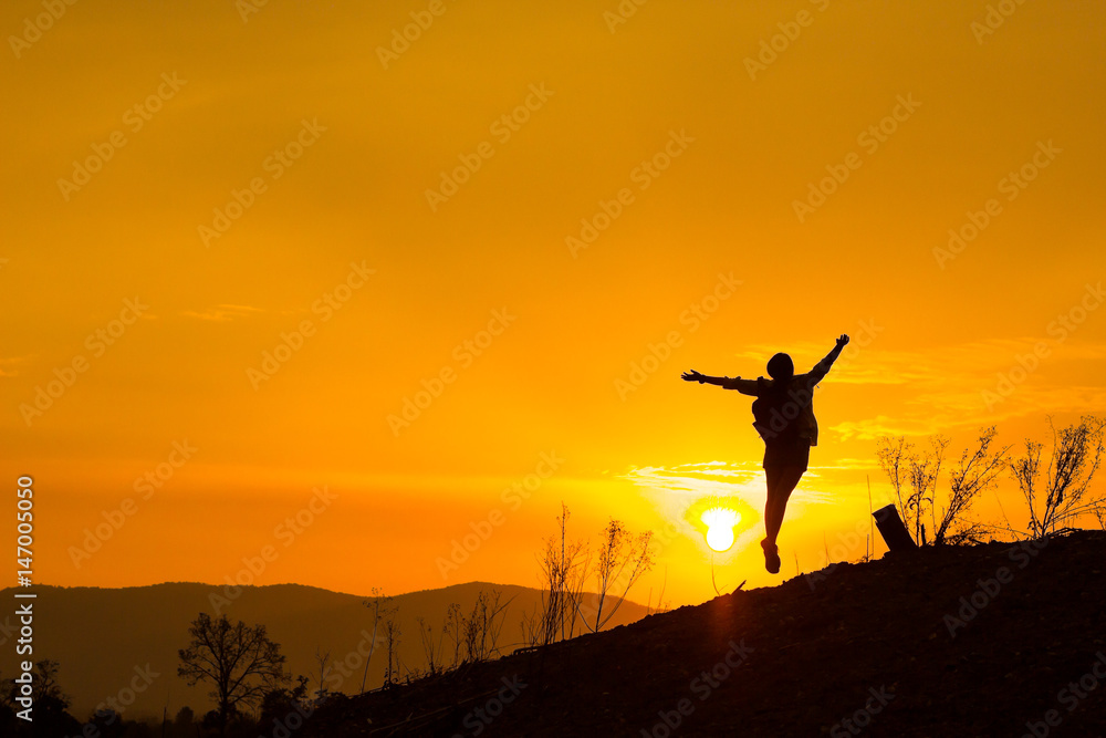 Woman backpacking to watch the sunset.Silhouette