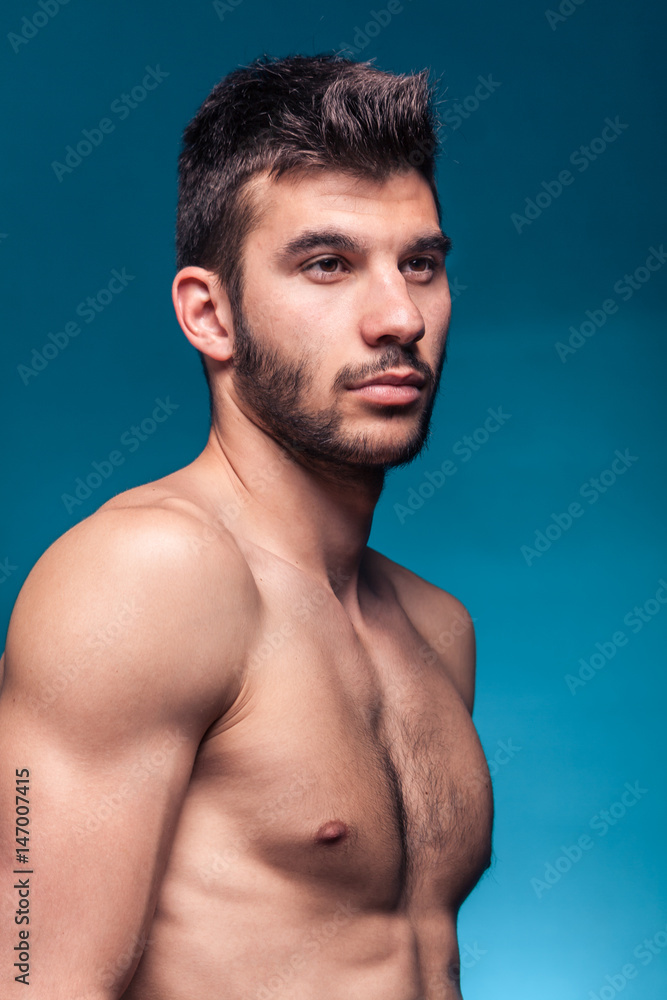 Fototapeta premium handsome face head shoulders, blue background studio
