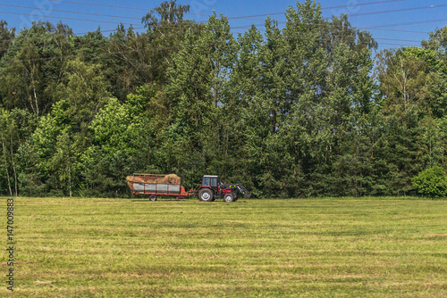 Tractor on a field - rural scene in Latvia