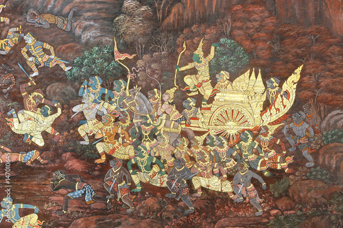 Traditional Thai painting art about Ramayana story on display at the temple wall Wat Prakaew in Bangkok, Thailand.