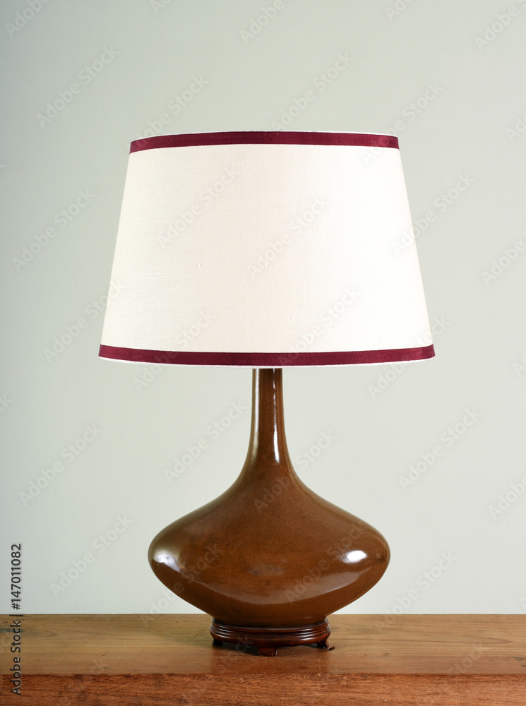 Fototapeta premium Elegant brown bulbous vintage lamp with shade