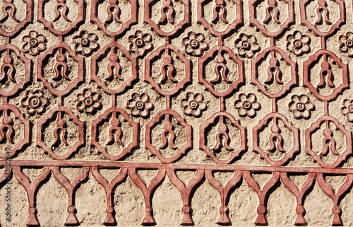 Bas-relief carving with floral ornament on old stucco wall, Mexico