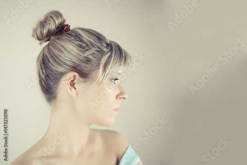 Profile of a beautiful young woman with a towel on her head