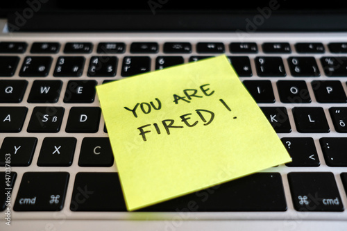 You are fired. Dismissal, downsizing, layoff message in office.