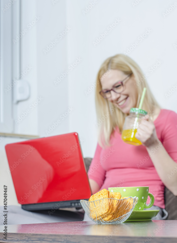 Young woman working at home, using laptop. Young woman working at home, using laptop.