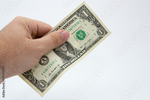 A close up photo of a Caucasian male hand holding a 1 dollar USA note 