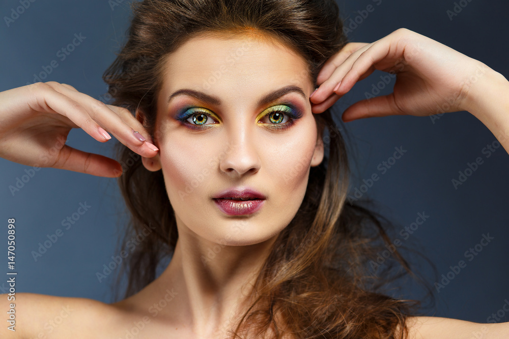Fototapeta premium Beauty portrait of a girl with clean skin and bright evening make-up.