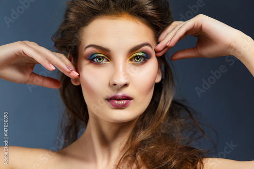 Beauty portrait of a girl with clean skin and bright evening make-up.