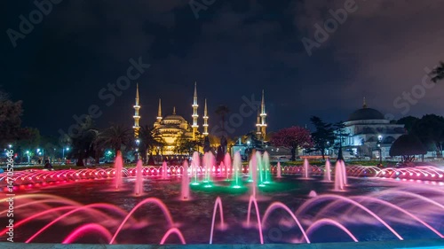 Fountain timelapse in front of The Blue Mosque Sultanahmet Mosque at night. Istanbul, Turkey photo