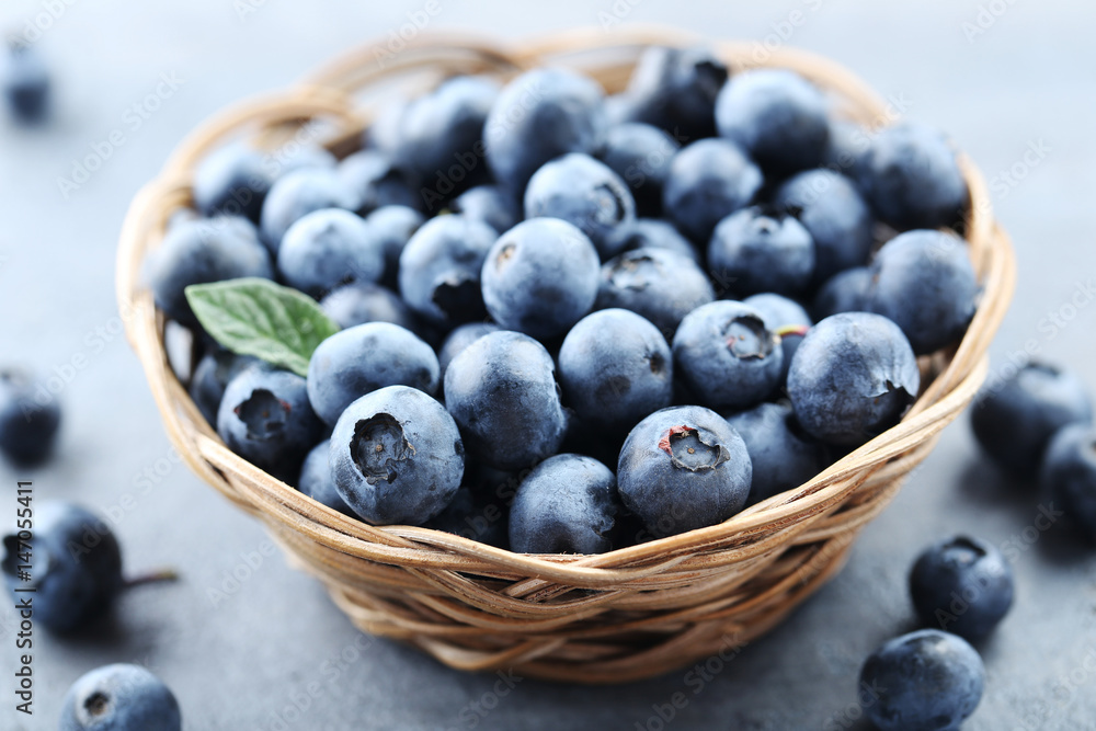 Ripe and tasty blueberries on grey wooden table Ripe and tasty blueberries on grey wooden table