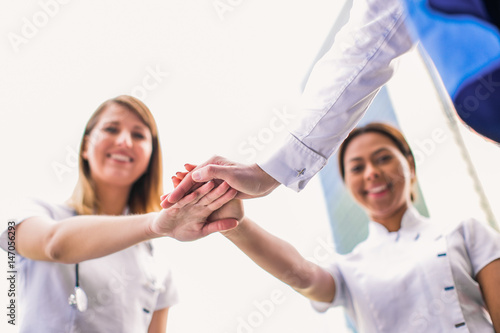 Close-up hands together of young team of the doctors  outdoors