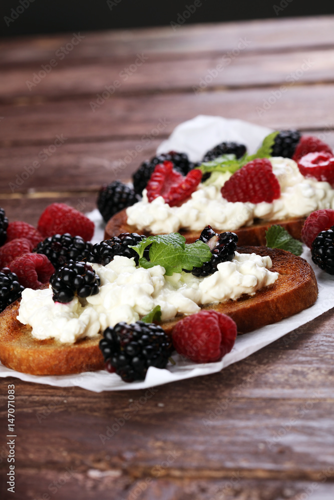 Bread with cheese cream and blackberries and raspberries for lun