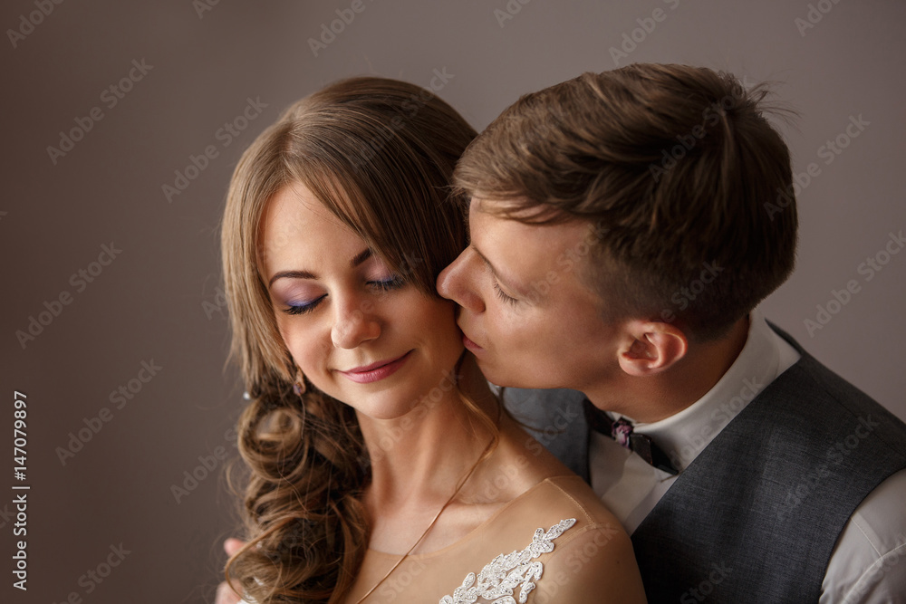 Wedding kiss, portrait of beautiful newlyweds, bride and groom kissing