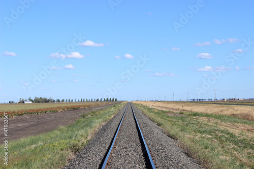 Railway line with crops and highway