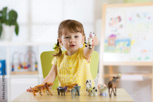 Child playing with animal t...