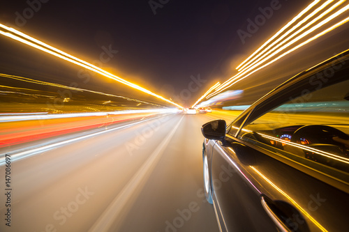 Photography View from Side of Car moving in a night city, Blured road with lights with car on high speed