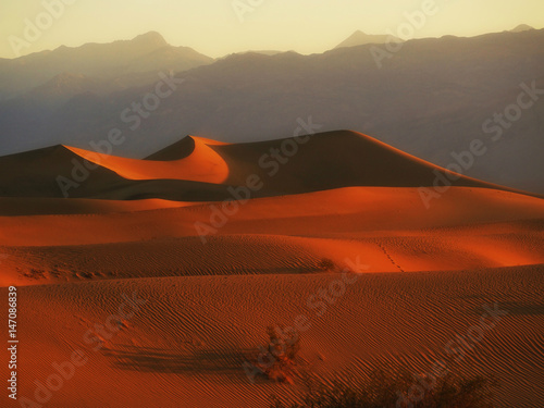 Sand Dunes And Mountains in sunrise  Death Valley National Park  California  USA