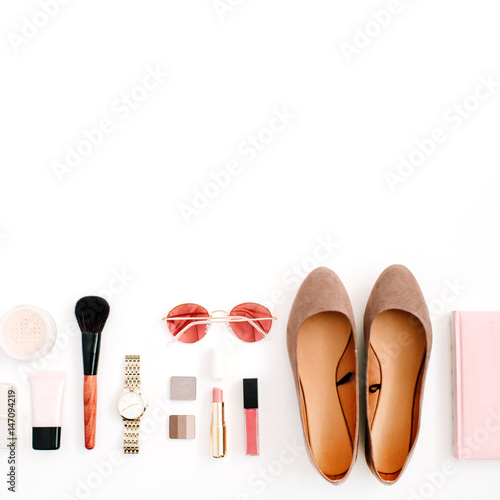 Beauty blog fashion concept. Female pink styled accessories: watches, sunglasses, cosmetics, shoes on white background. Flat lay, top view trendy feminine background.