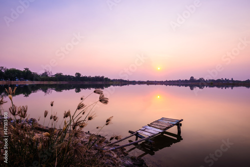 wooden bridge at the lake on sunset © songdech17
