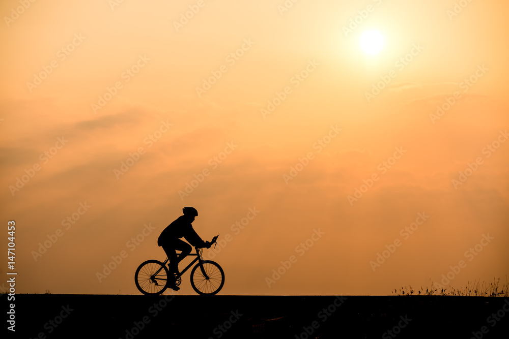 Silhouette of cyclist on sunset background Silhouette of cyclist on sunset background