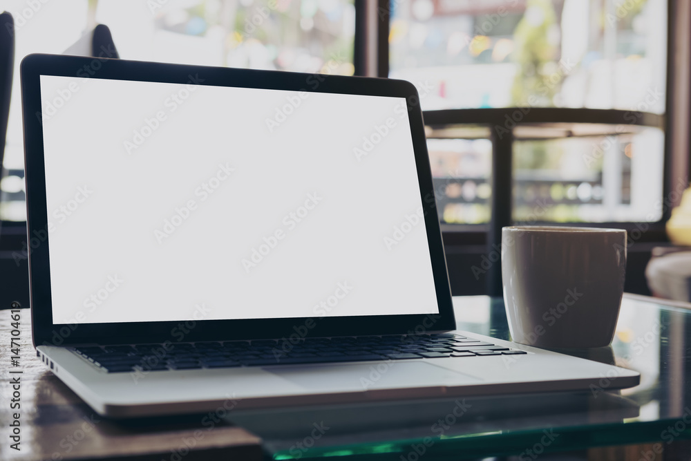 Mockup image of laptop with blank white screen on wooden table in modern loft cafe Mockup image of laptop with blank white screen on wooden table in modern loft cafe