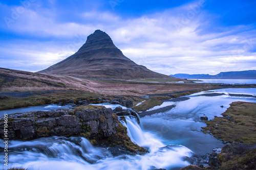 Kirkjufell is a free standing mountain of the Snaefellsnes peninsula, on the northern coast of Iceland. Together seen with the mountain, is a waterfall called Kirkjufellsfoss that flows into the sea.