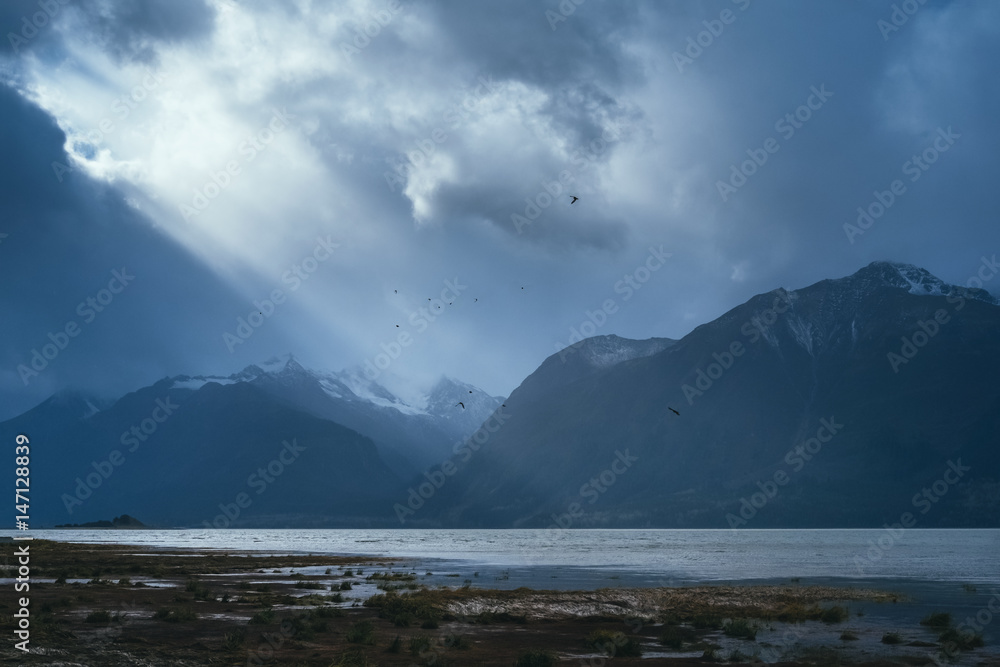 Sun Breaks Through the Clouds on Remote Alaska Landscape 