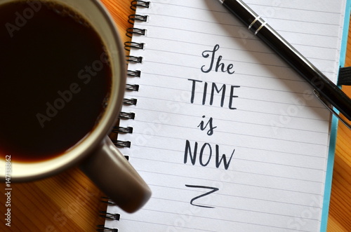 Quote on notepaper “THE TIME IS NOW”