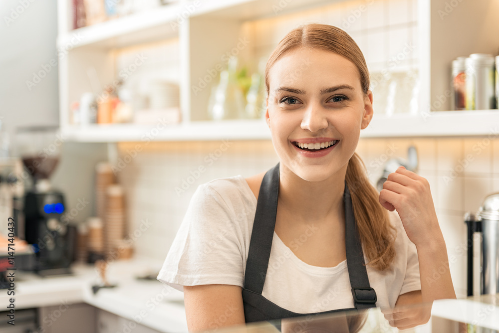 Cute blond girl enjoying work in coffee house Cute blond girl enjoying work in coffee house