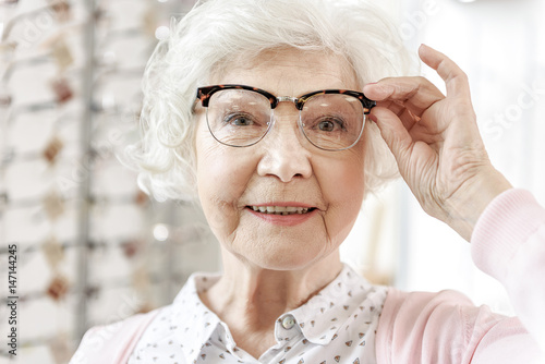 Joyful senior woman in optic store