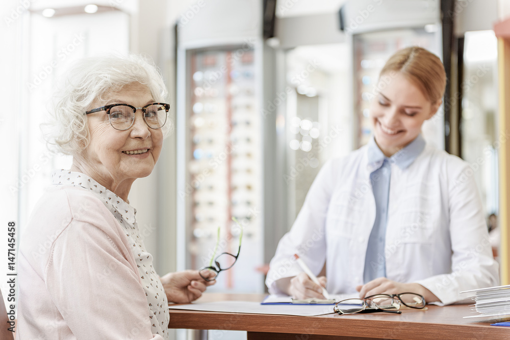 Joyful mature lady in optic store Joyful mature lady in optic store