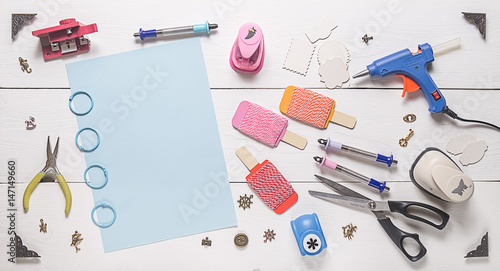 top view of wooden table with tools for scrapbooking