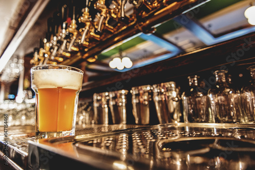 Cold beer in glass locating on table