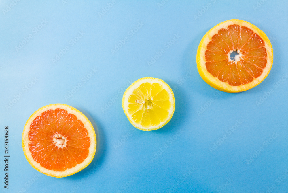 custom made wallpaper toronto digitalOne grapefruit and two lemon slices on blue background.