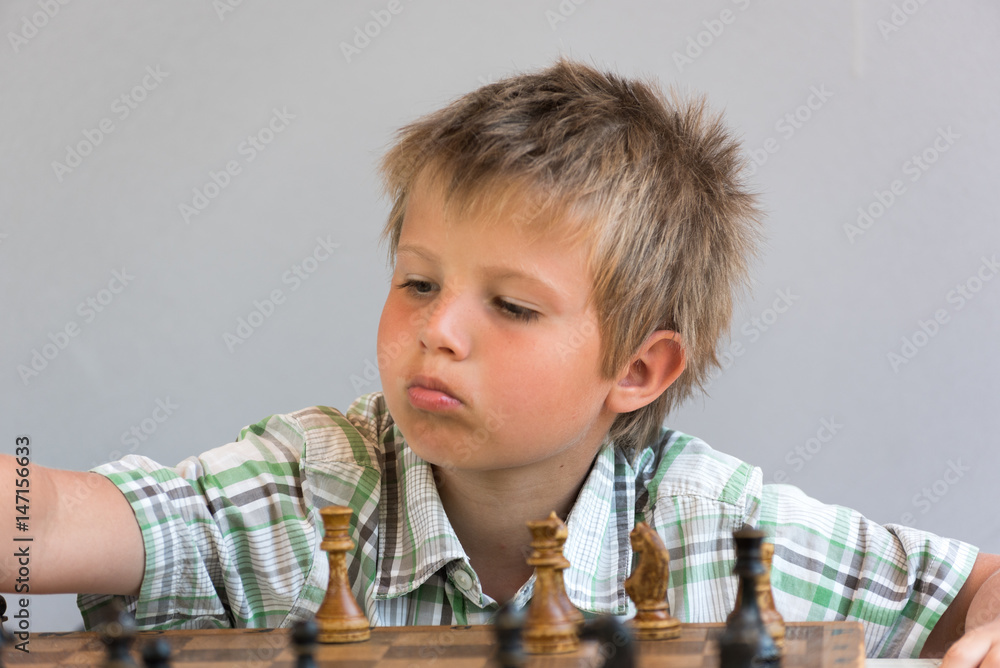 Portrait of a boy playing chess Portrait of a boy playing chess