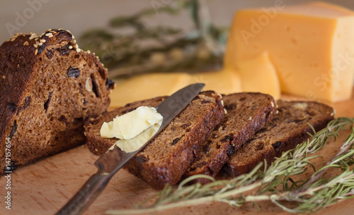 dark bread with nuts and raisins, butter and cheese