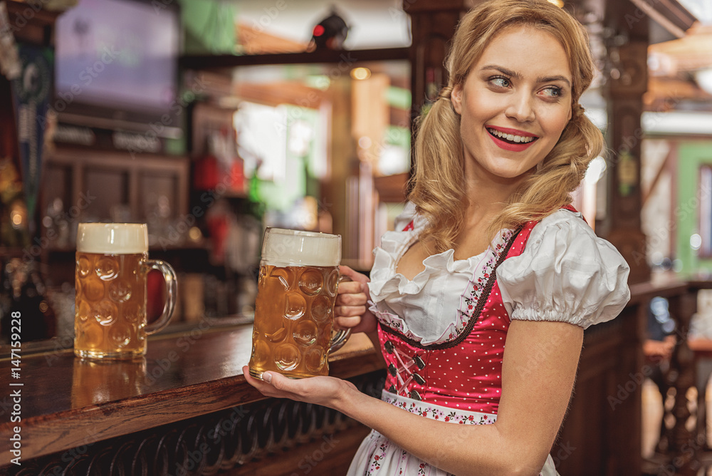 Outgoing woman serving glasses of beer