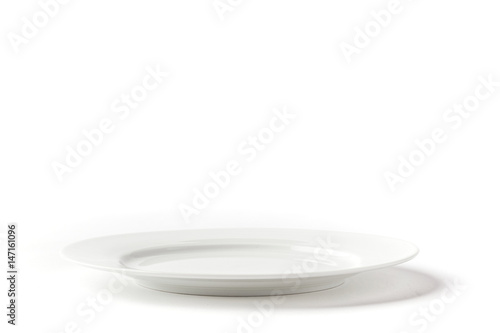 White medium plate on white background from side