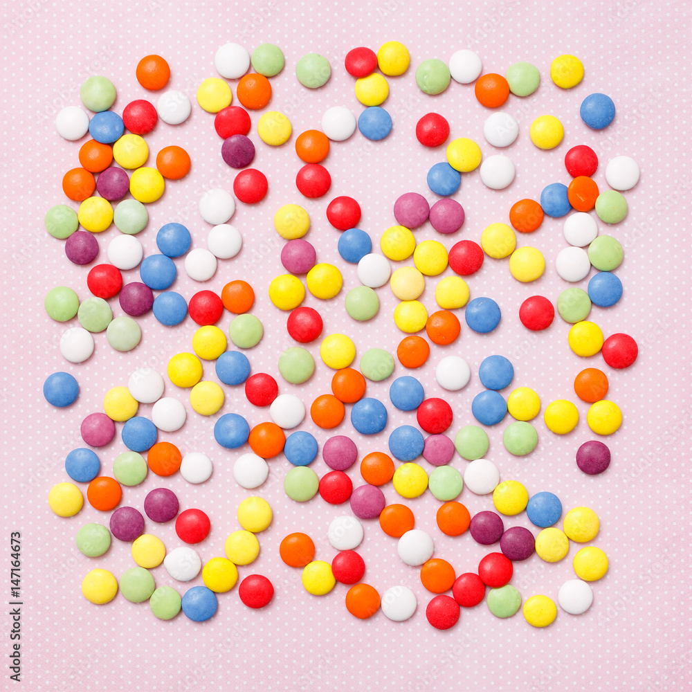 Fototapeta premium Lollipops sweets. Candy, top view flat lay on pink background. Sweet sucker, lollipop