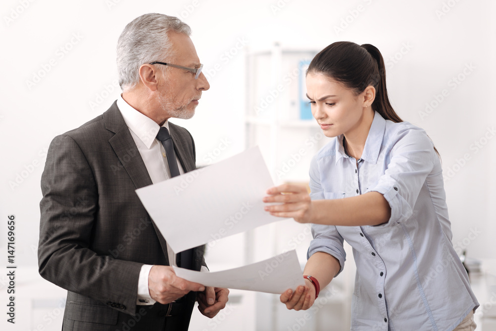 Confused office worker looking for necessary document Confused office worker looking for necessary document