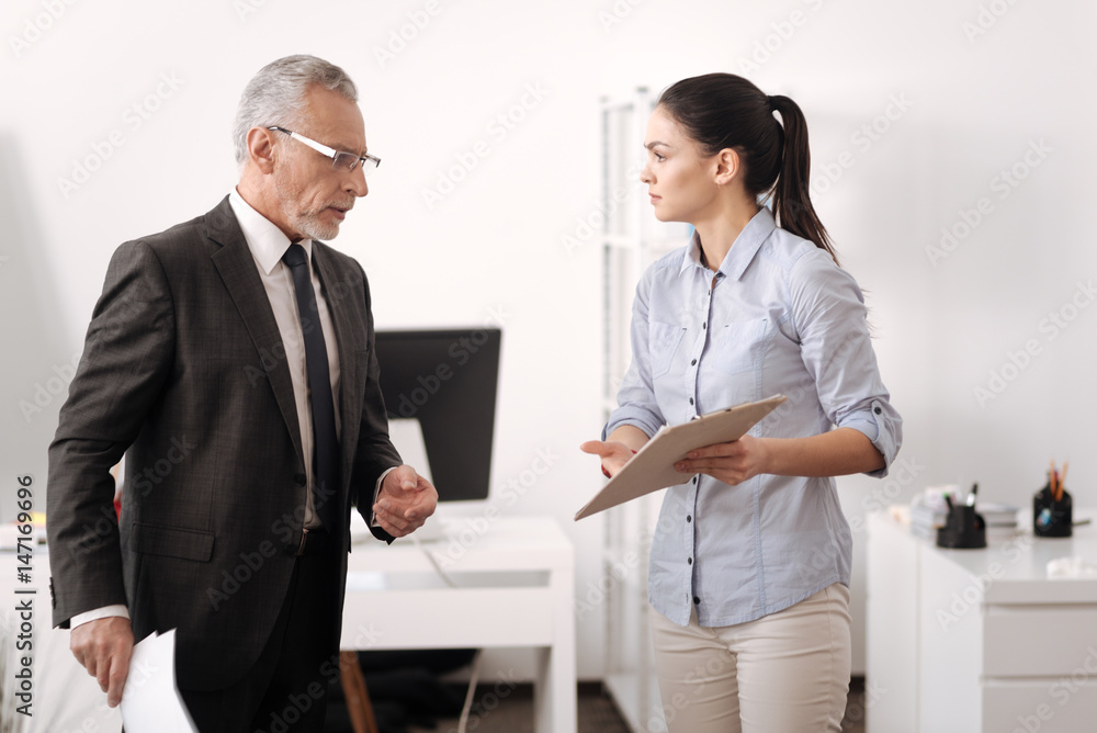 Sad young woman showing folder with result Sad young woman showing folder with result