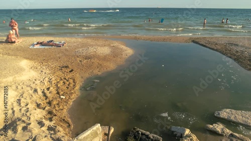 Wallpaper Mural Sewage on the beach. Dirty water and sand. Sea pollution facts. Torontodigital.ca