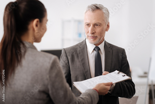Slika na platnu Handsome delighted male person taking documents