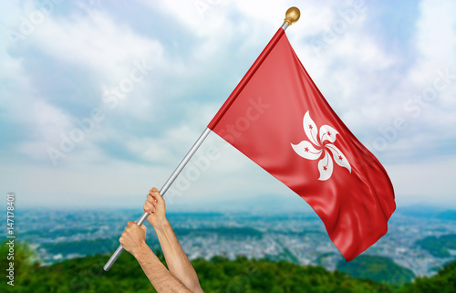 Young man's hands proudly waving the Hong Kong national flag in the sky, part 3D rendering photo